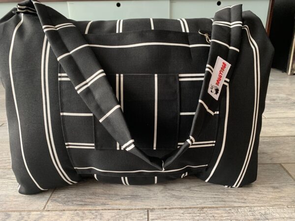 Black dog bed bag with white stripes on it and a tag of DoggyToGo