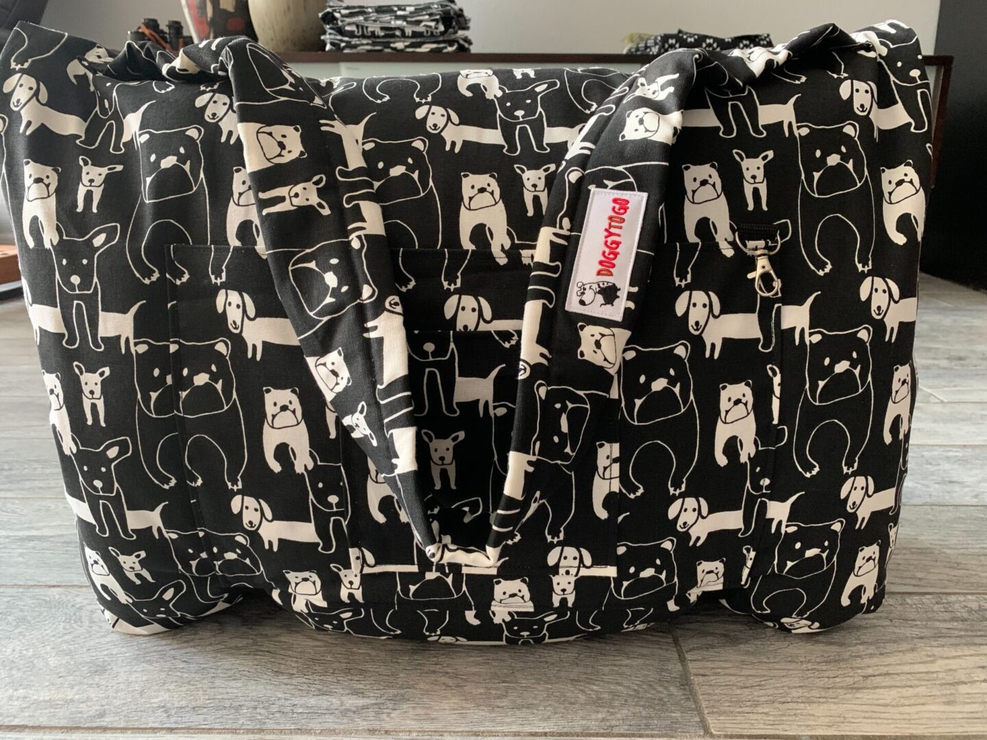An enlarged image of a black color bed bag with white color designs on it