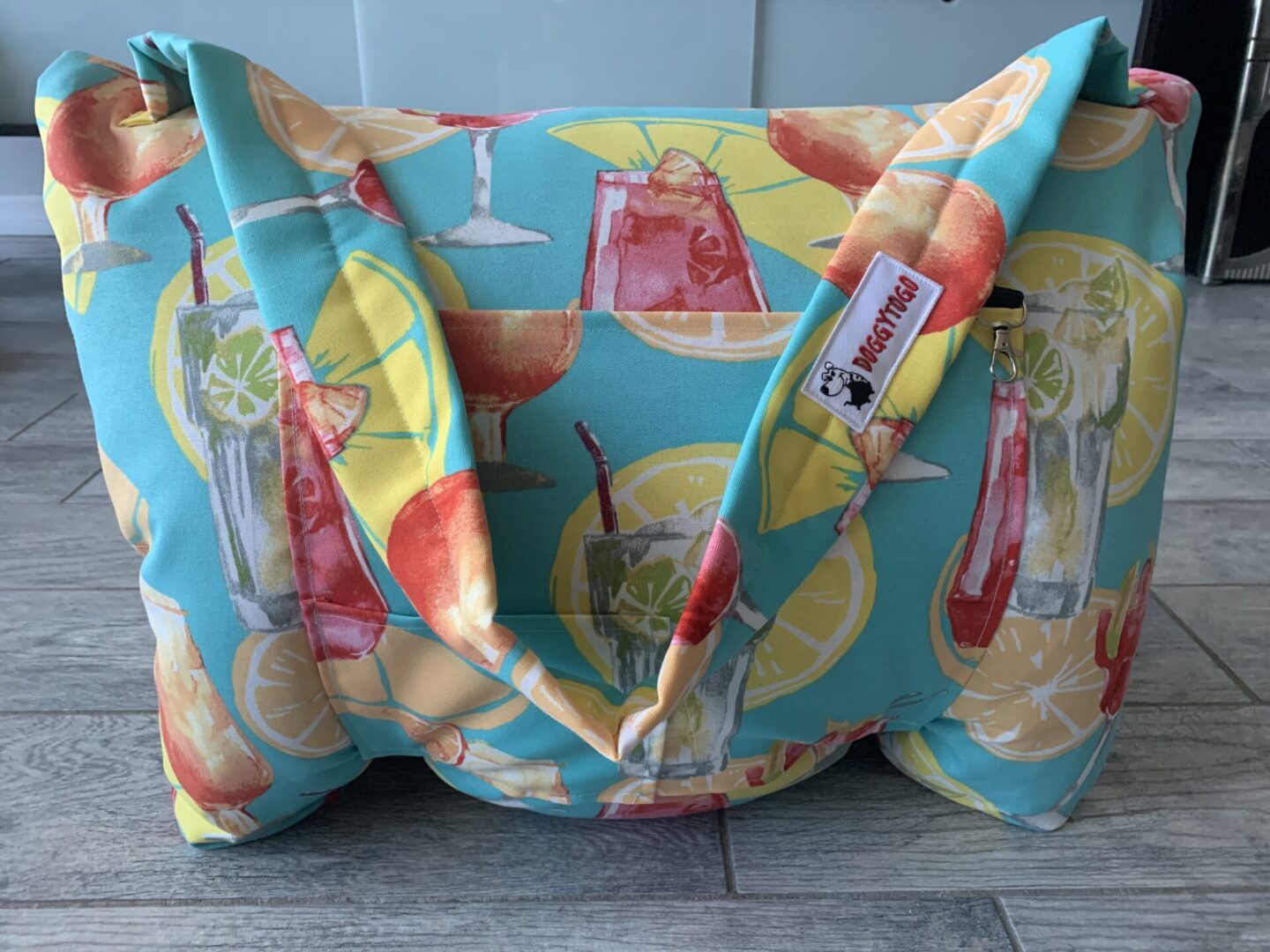 A dog bed bag with blue, yellow, and red color patterns