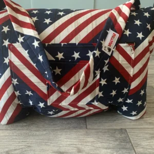 A dog bed bag with the pattern of the United States of America flag printed on it