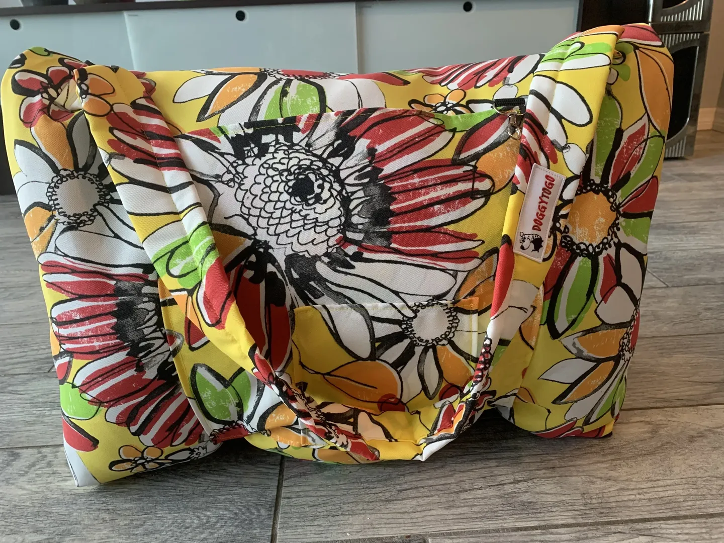 A dog bed bag with a multicolor design