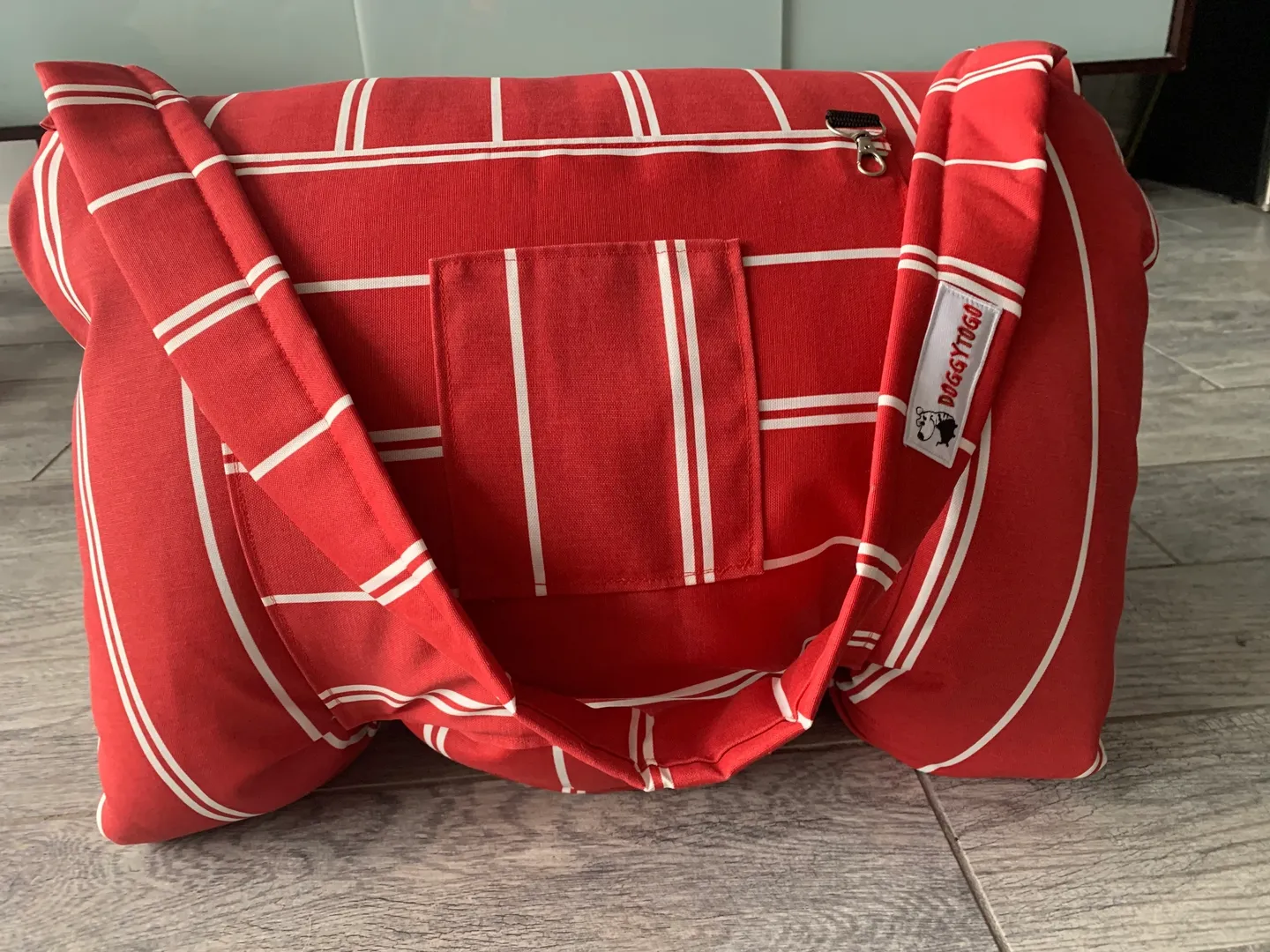 A red color dog bed bag with white stripes
