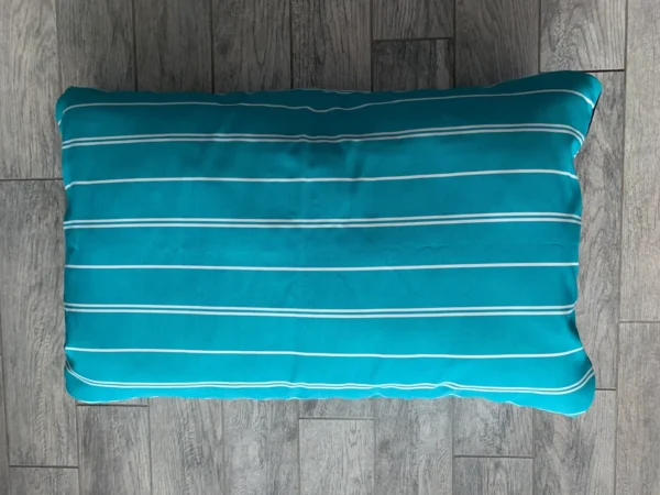 A blue colored bed bag for dogs placed on the floor