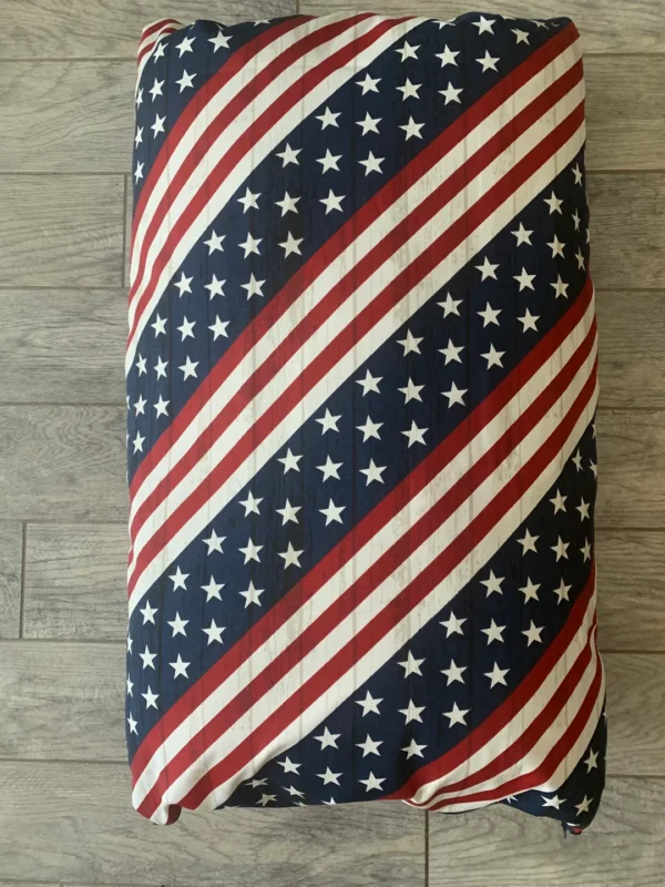 A dog bed bag with the design of the USA national flag printed on it
