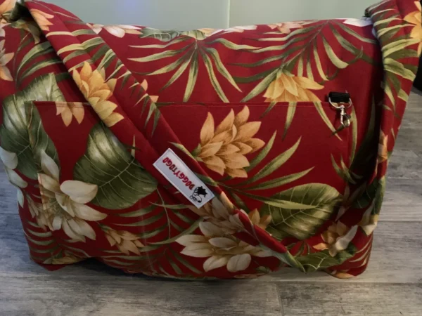 A tiny image of a red colored dog bed bag with colorful flowers printed on it